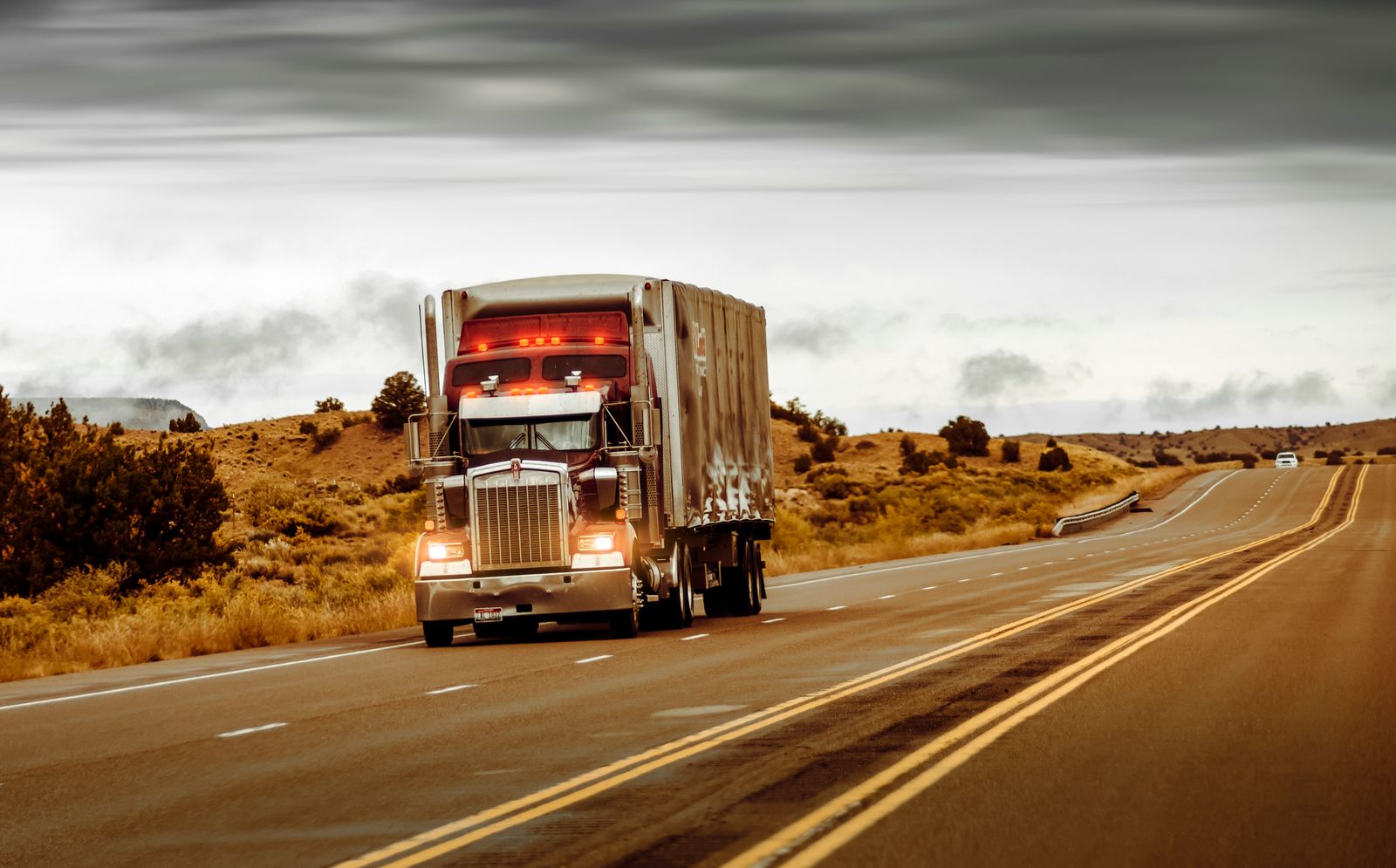 A classic American truck on an open western highway at golden hour